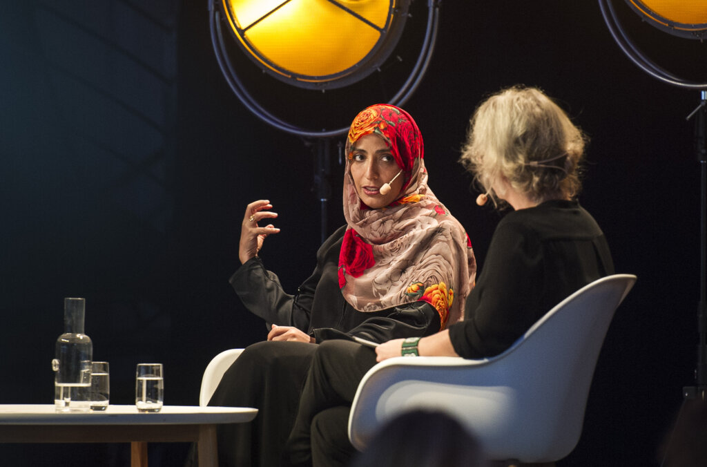 Two women talking on a stage