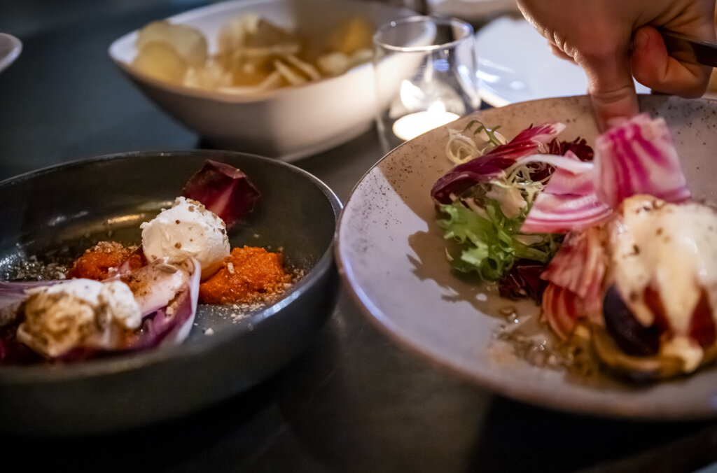 Image of two plates of food and a bowl of chips